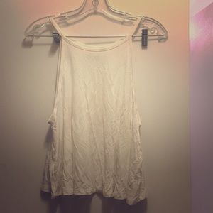 Off-white tank top with low sides.